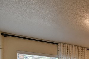 Bedroom with Carpet, Bedside Dresser, Blue Wall, Ceiling Light and Window